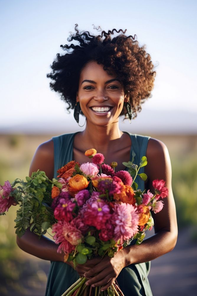 Black woman holding bouquet flower portrait smiling plant.