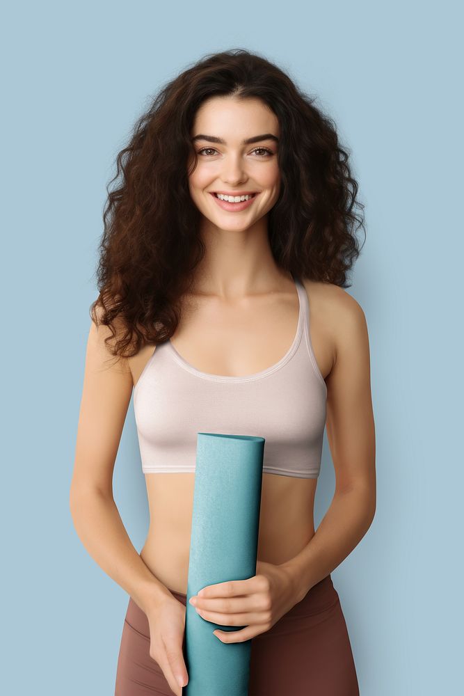 Happy woman holding yoga mat