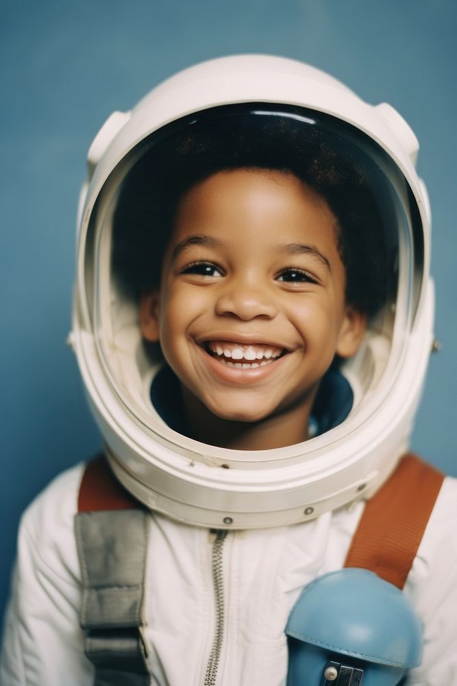 African boy wearing white astronaut suit helmet smile happy.