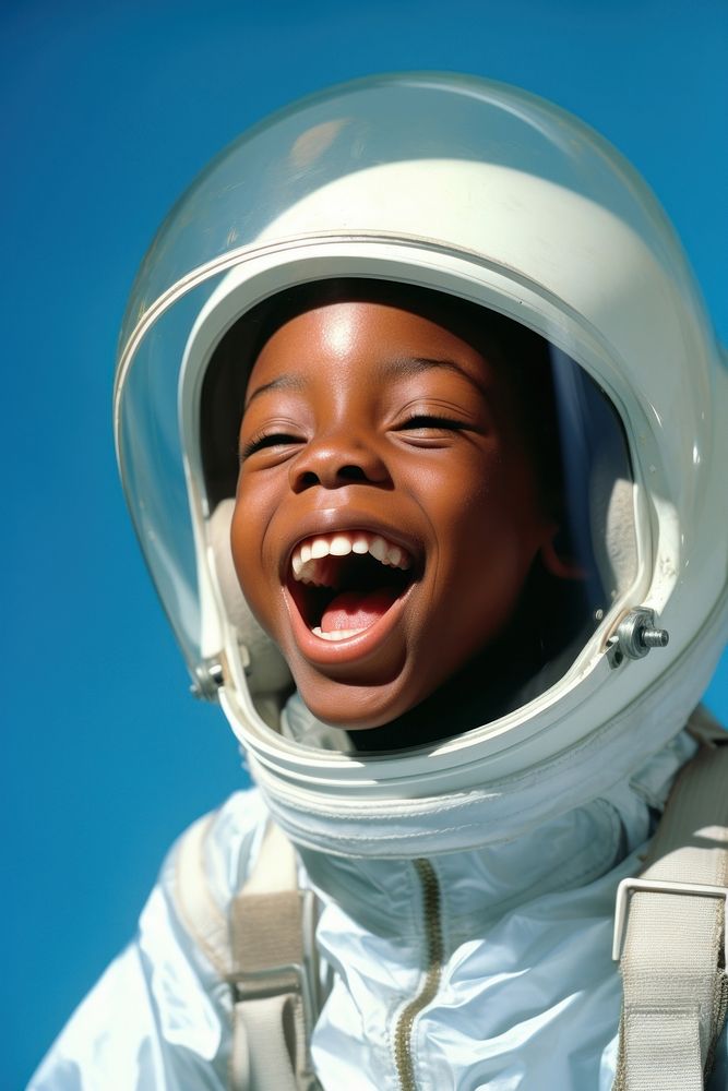 African boy wearing white astronaut suit laughing happy blue.