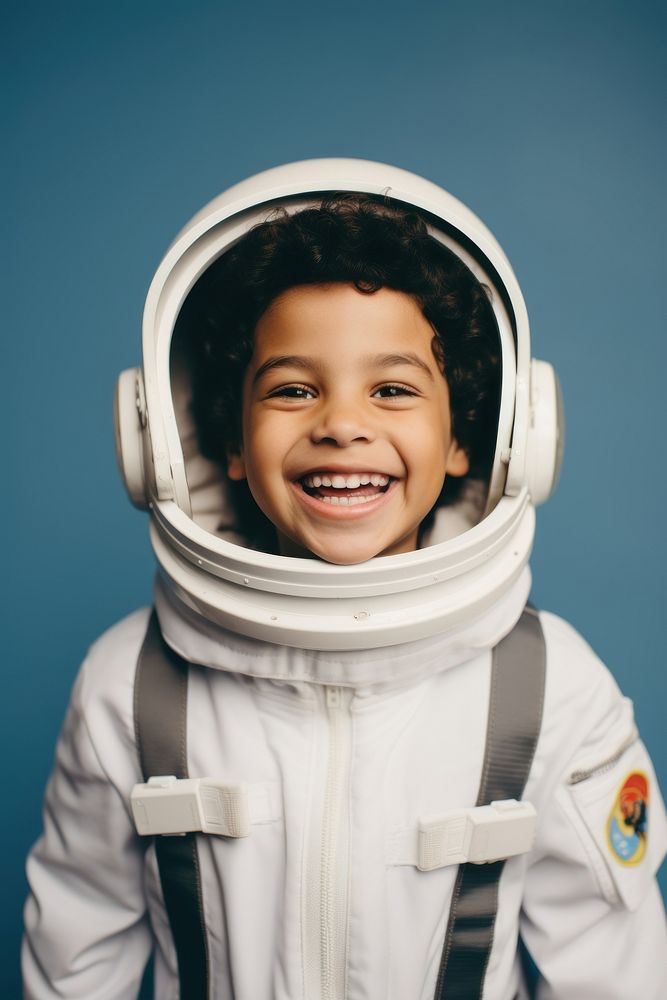 Latinx boy wearing white astronaut suit smile happy exploration.