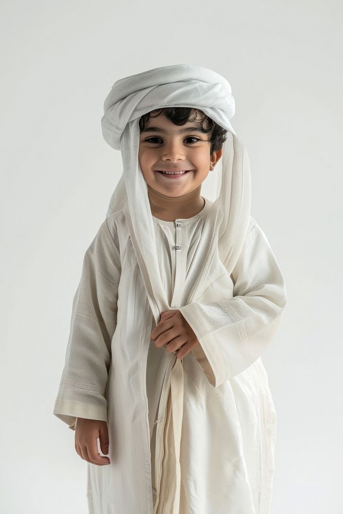 Saudi Arabia boy standing adult headscarf.