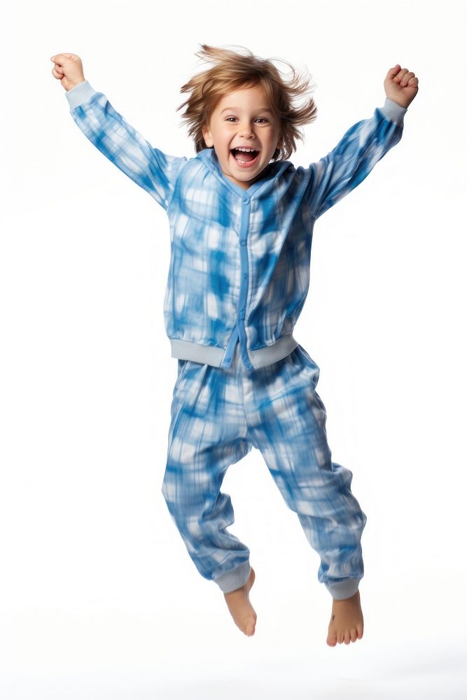 A boy in pajamas happy white background excitement.