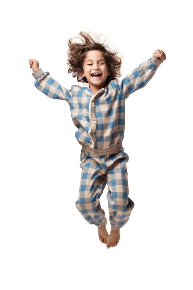 A boy in pajamas jumping happy white background.