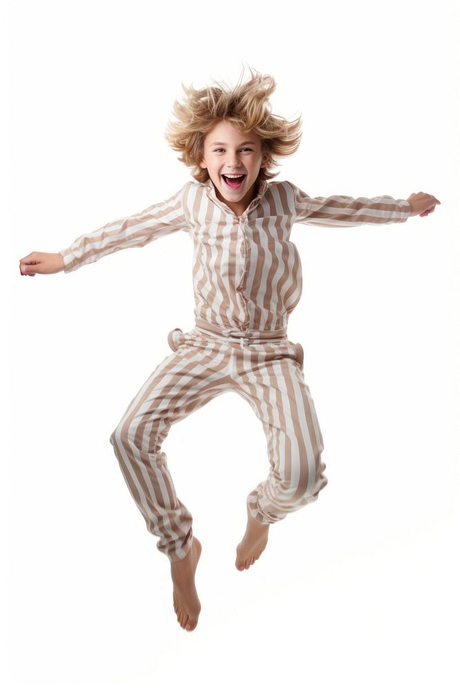 A boy in pajamas jumping white background celebration.