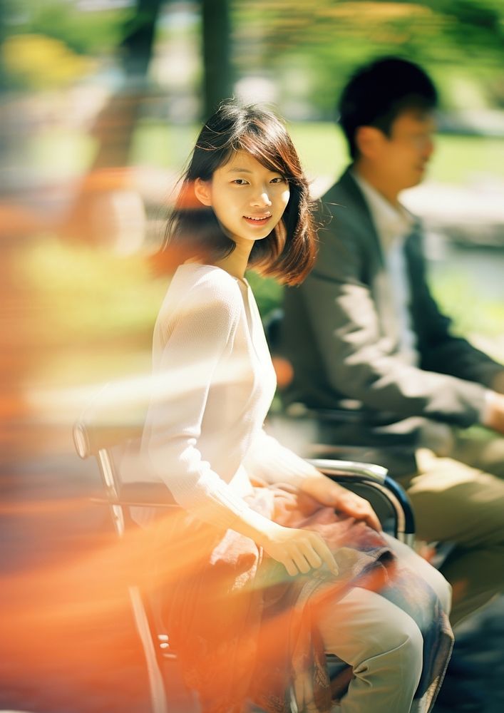 A motion blur couple sitting in the park portrait photography adult.