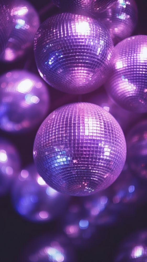  A purple disco balls illuminated backgrounds celebration. AI generated Image by rawpixel.