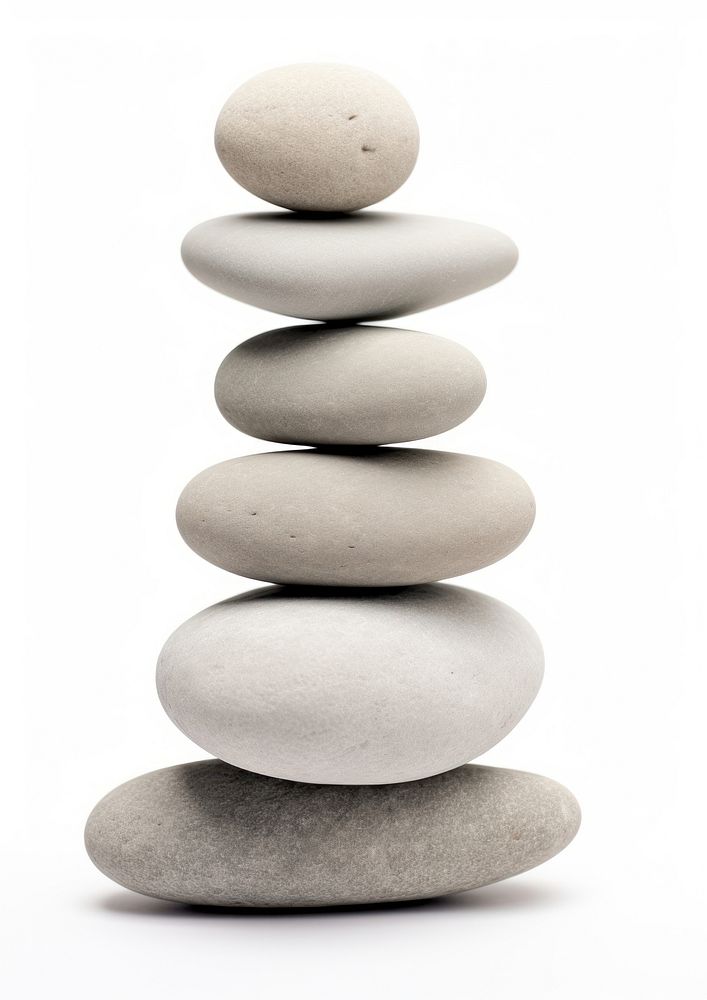 A seven stacked stone pebble rock white background.
