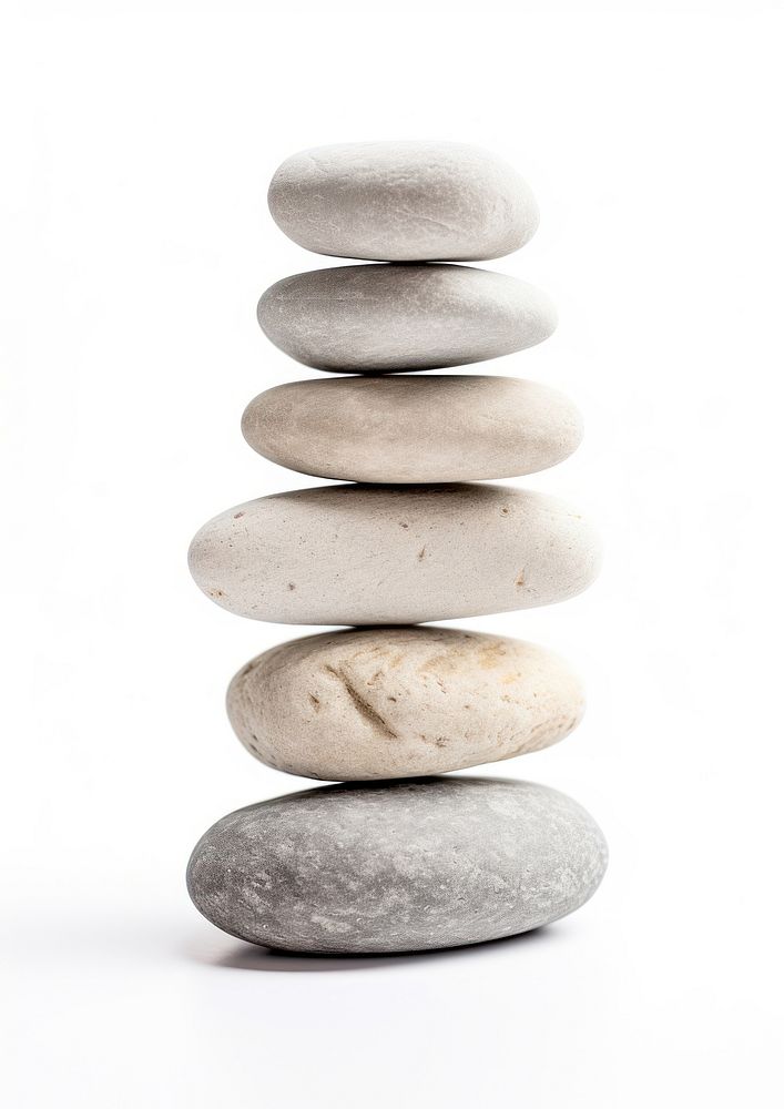 A seven stacked stone pebble rock white background.