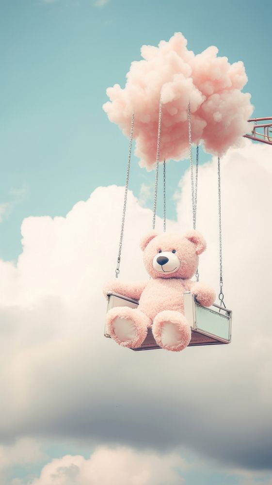 A teddy bear side on cotton candy outdoors nature sky.
