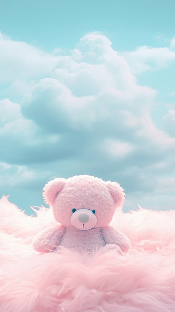 A teddy bear sits on cotton candy toy representation softness.