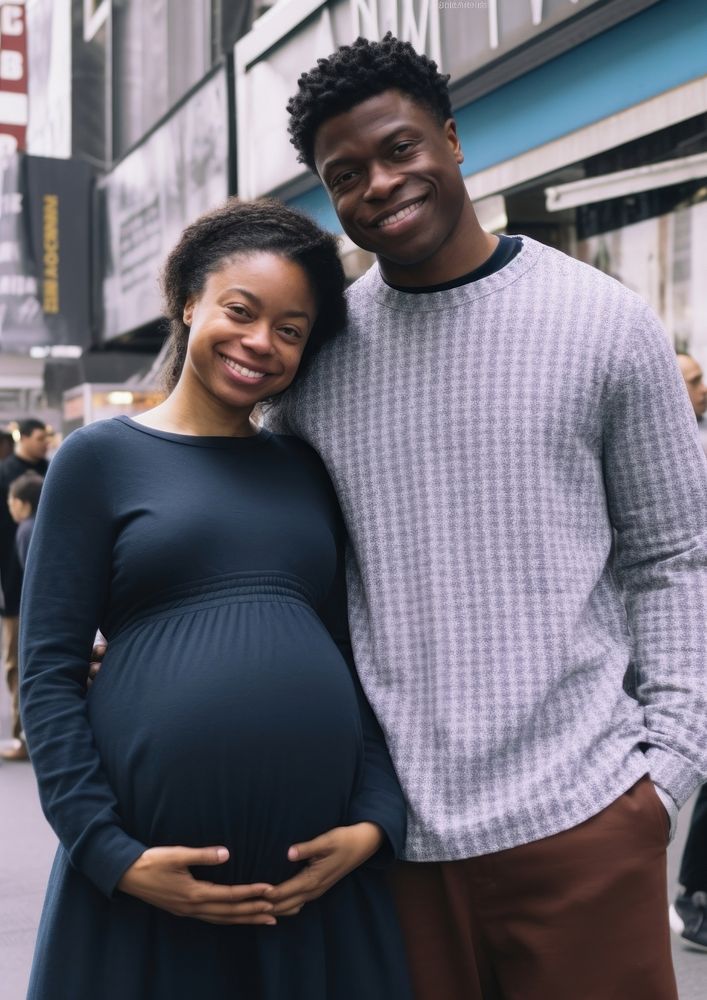 Black man holding hand pregnant woman portrait family adult.