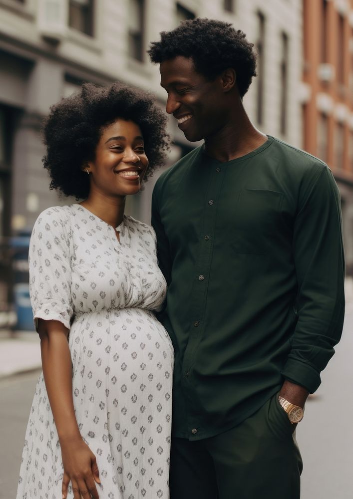 Black man holding hand pregnant woman portrait adult happy.
