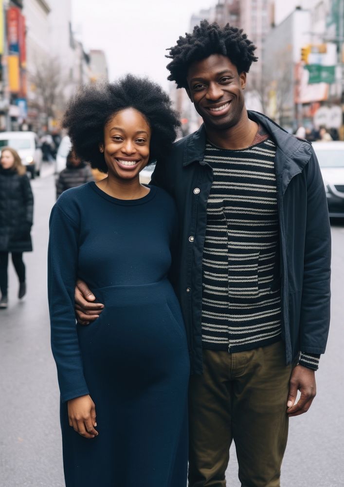 Black man holding hand pregnant black woman street adult smile.