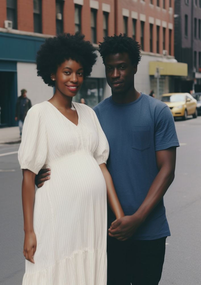 Black man holding hand pregnant black woman street portrait adult.