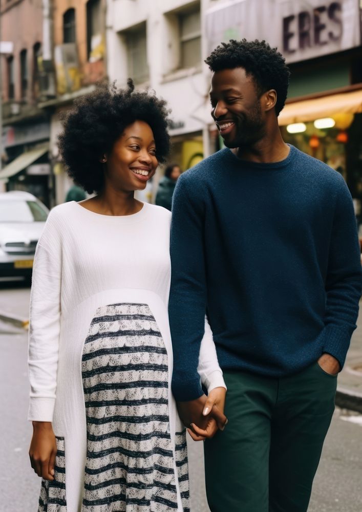 Black man holding hand pregnant black woman street adult happy.