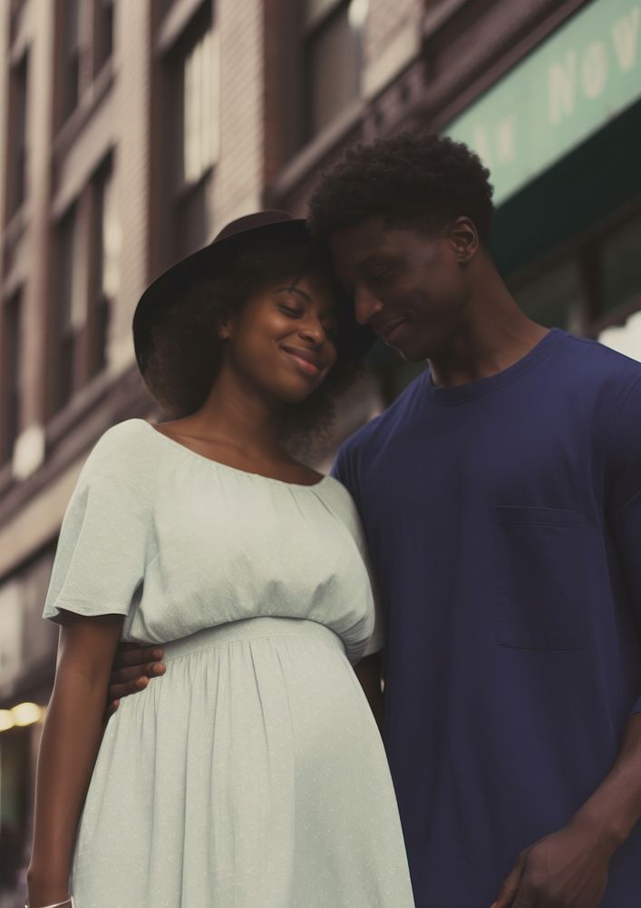 Black man holding hand pregnant black woman portrait adult photo.