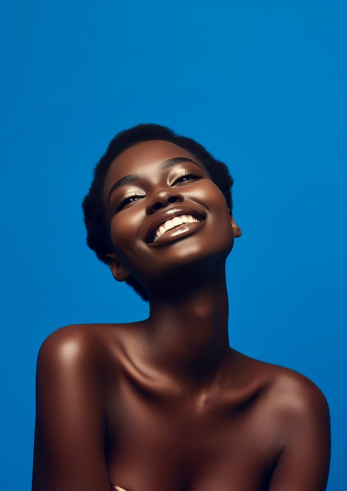 A black woman smile with navy eye shadow photography portrait fashion.