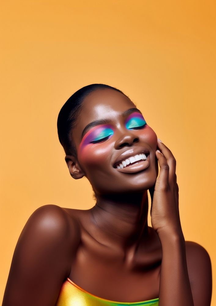 A black woman smile with colorful eye shadow makeup photography portrait fashion.