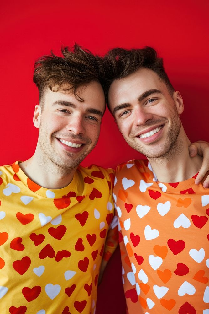 Couple gay man wearing heart-shaped matching shirts smiling smile adult.