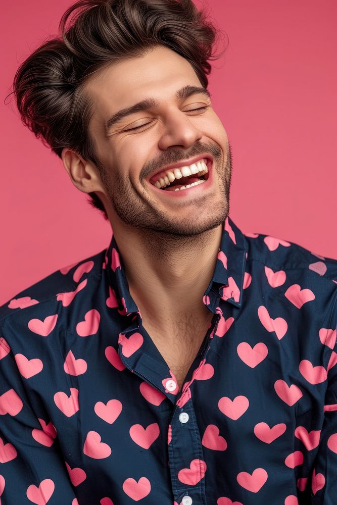 Man wearing heart-shaped matching shirts laughing smiling adult.