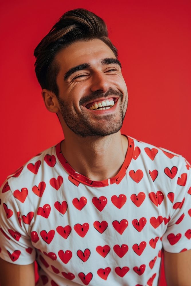 Man wearing heart-shaped matching shirts laughing smiling adult.