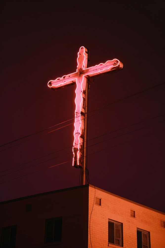 Neon cross crucifix building symbol.