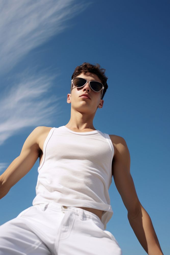A young man wearing acetate frame sunglasses and a white tanktop blue sky accessories.