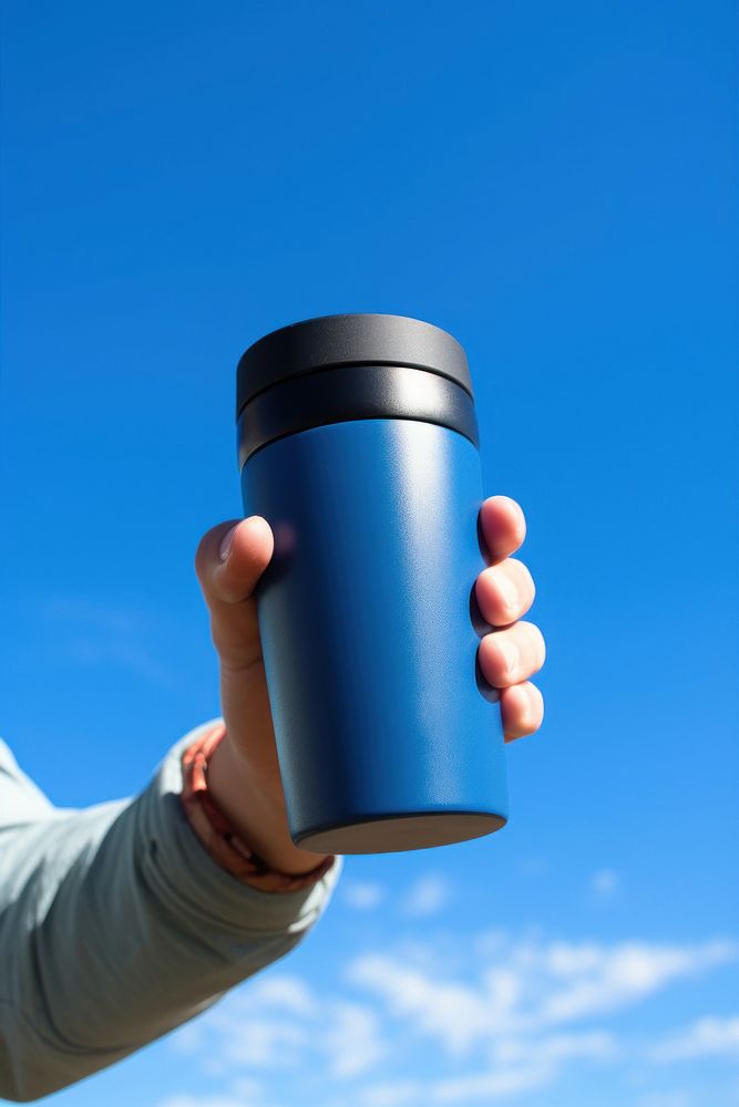 Holding hydro flask coffee mug with flex sip lid blue cup sky.