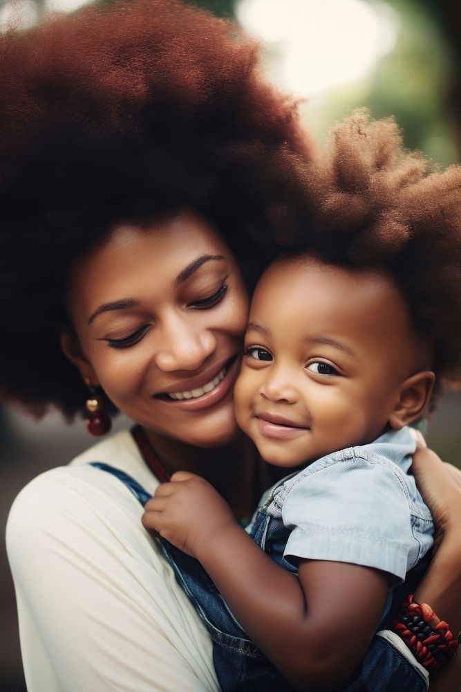Black mom holding a tiny child photography portrait hugging.