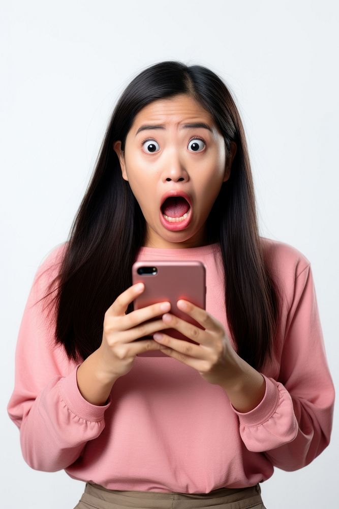 A Young woman reacts to shocking news on her phone holding adult white background. AI generated Image by rawpixel.
