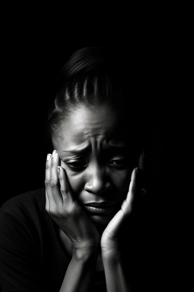 Sad desperate grieving crying black woman with folded hands and tears eyes during trouble portrait worried loss.