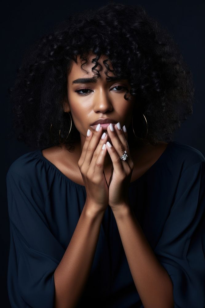 Sad desperate grieving crying black woman with folded hands and tears eyes during trouble portrait adult photography.