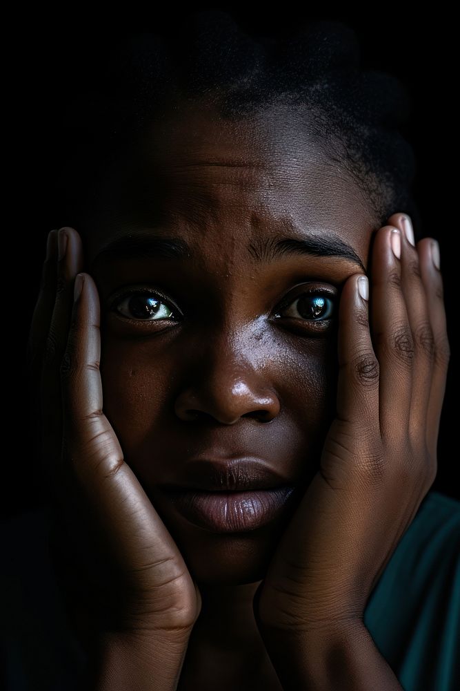 Sad desperate grieving crying black woman with folded hands and tears eyes during trouble portrait worried loss.