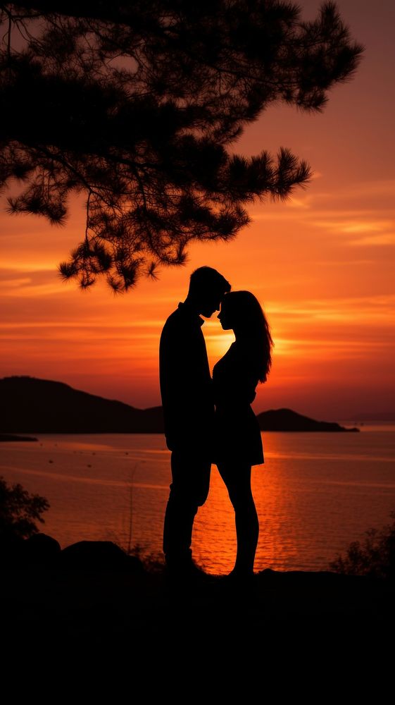  Silhouette of a couple sharing a gentle embrace backlighting outdoors romantic. AI generated Image by rawpixel.