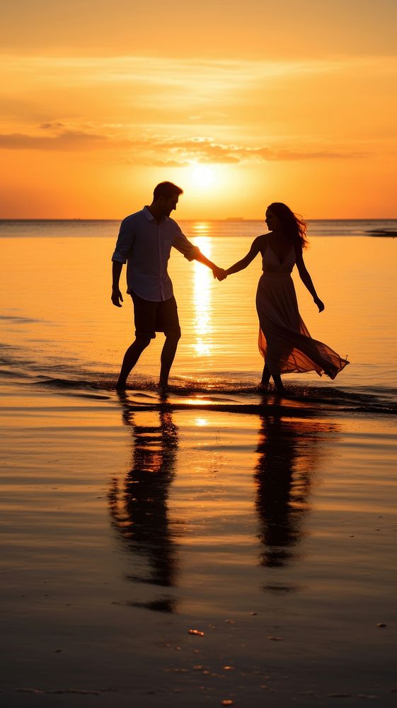  Playful moment captured as a couple holds hands and skips joyfully along a serene beach at sunset outdoors nature ocean. AI…