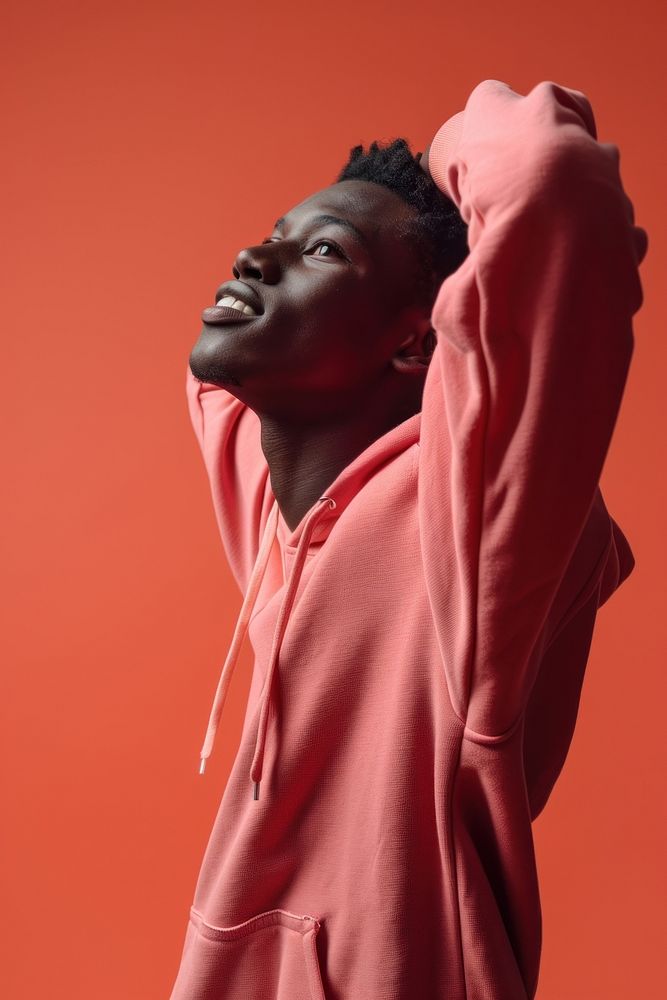 Young black man in sweatshirt with his arm up over his back head photography portrait happy. AI generated Image by rawpixel.