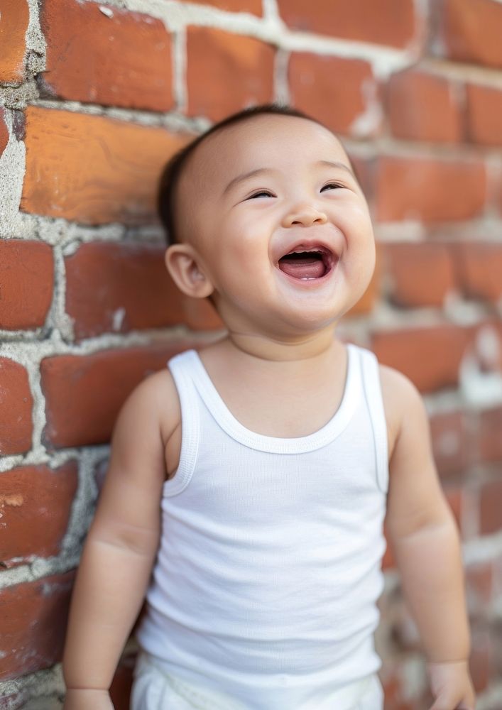 Tank top portrait baby laughing.