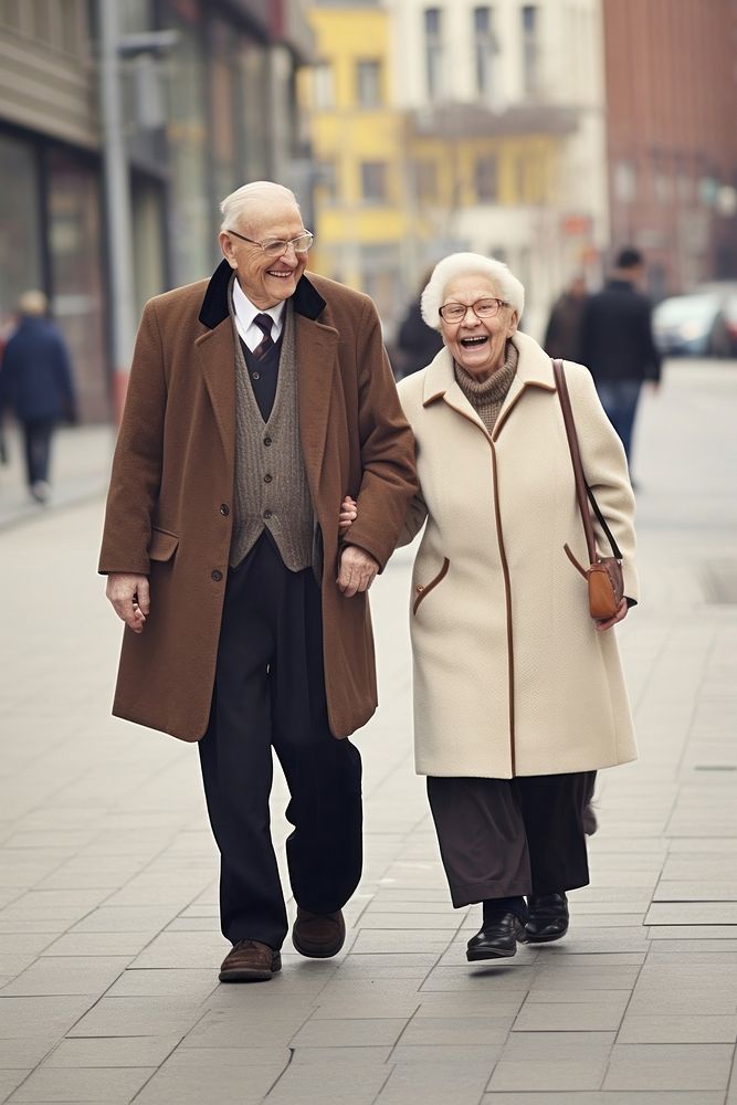 A old couple walking in the street overcoat adult togetherness.