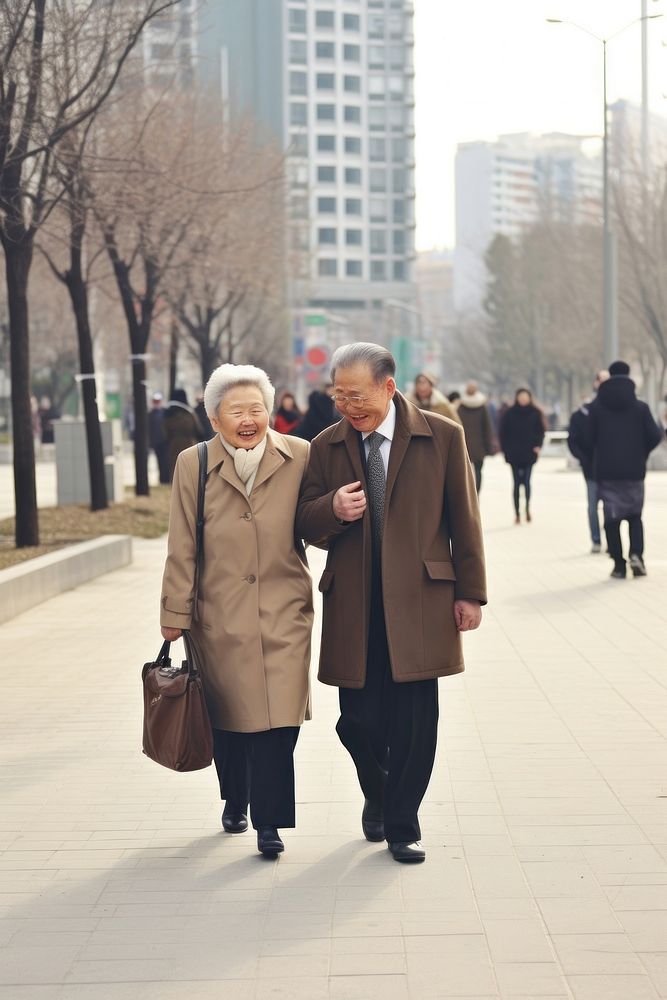 A old couple walking in the street overcoat footwear snapshot.