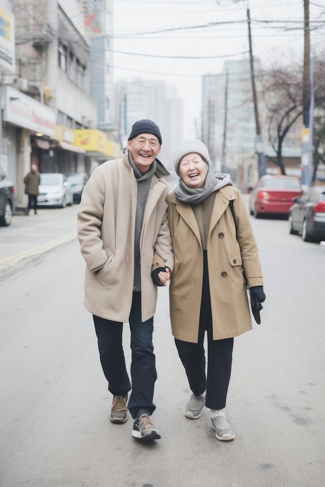 A adult couple walking in the street footwear snapshot glove.