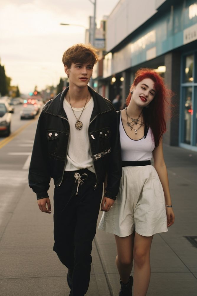 A teen couple walking in the street footwear portrait jacket.