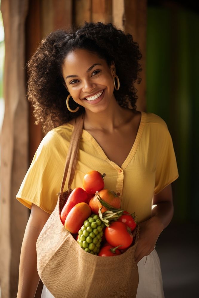 A joyful young Cuban woman holding a bag full of fruits and vegetable photography portrait smile.