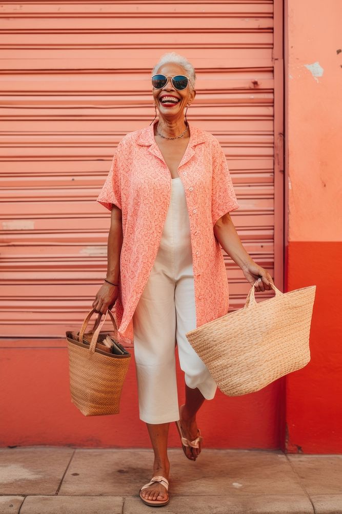 A joyful Cuban senior woman holding shopping basket footwear red architecture.
