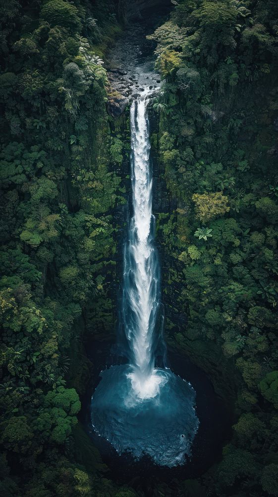 Aerial top down view of stunning waterfall landscape outdoors woodland.