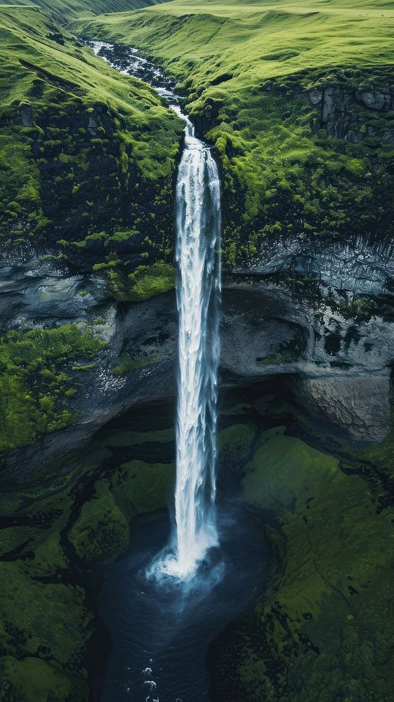 Aerial top down view of stunning waterfall landscape outdoors nature.