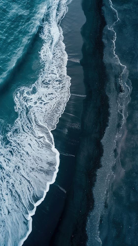 Aerial top down view of stunning black beach outdoors nature ocean.