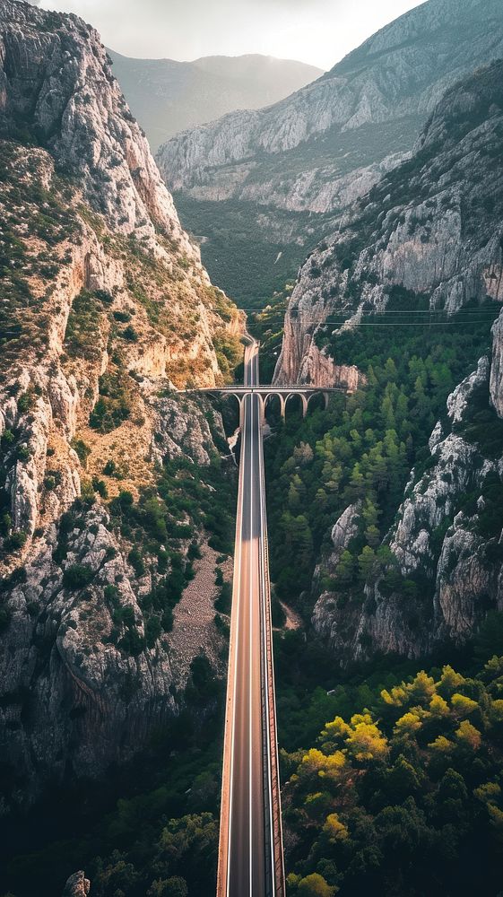 Aerial top down view of stunning bridge against mountain architecture landscape outdoors.