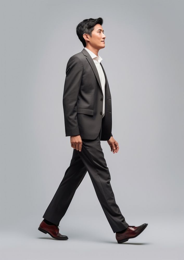 A chinese businessman walking tuxedo blazer. AI generated Image by rawpixel.