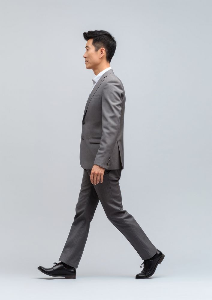 A chinese businessman walking tuxedo blazer. AI generated Image by rawpixel.